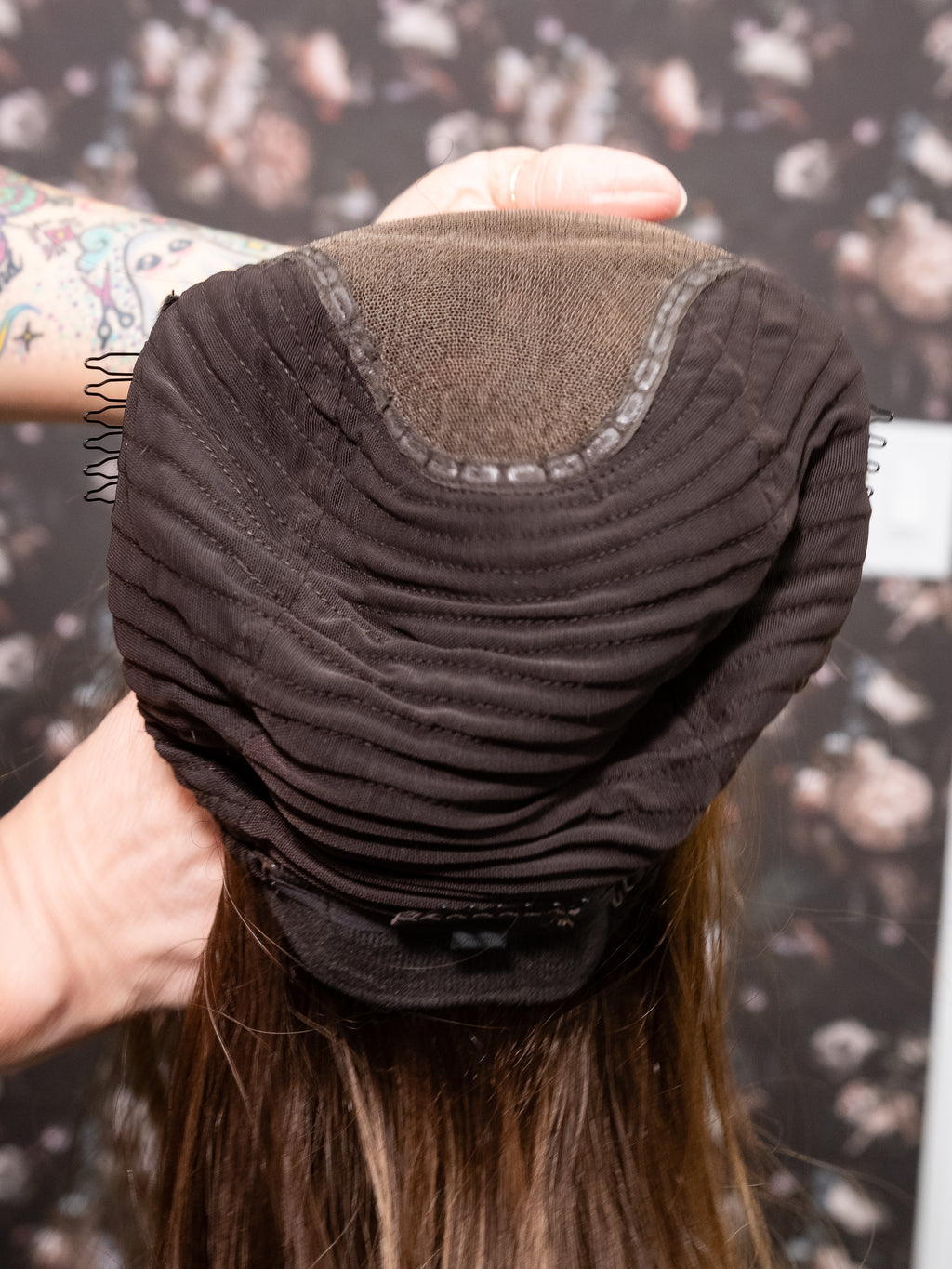 Person holding a hair extension with a blurred background
