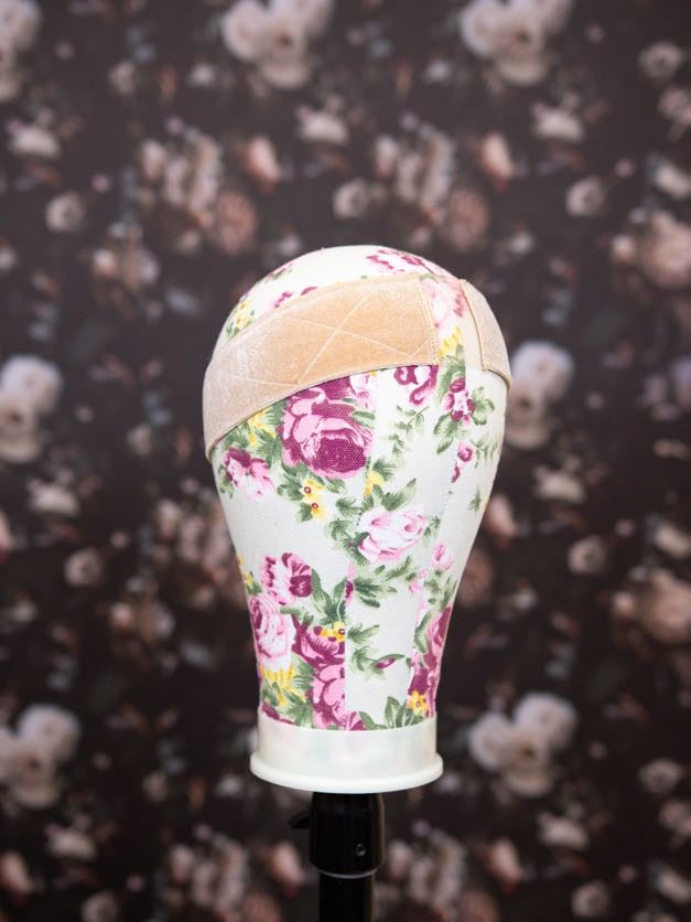 Floral-patterned headband on a mannequin head against a floral background