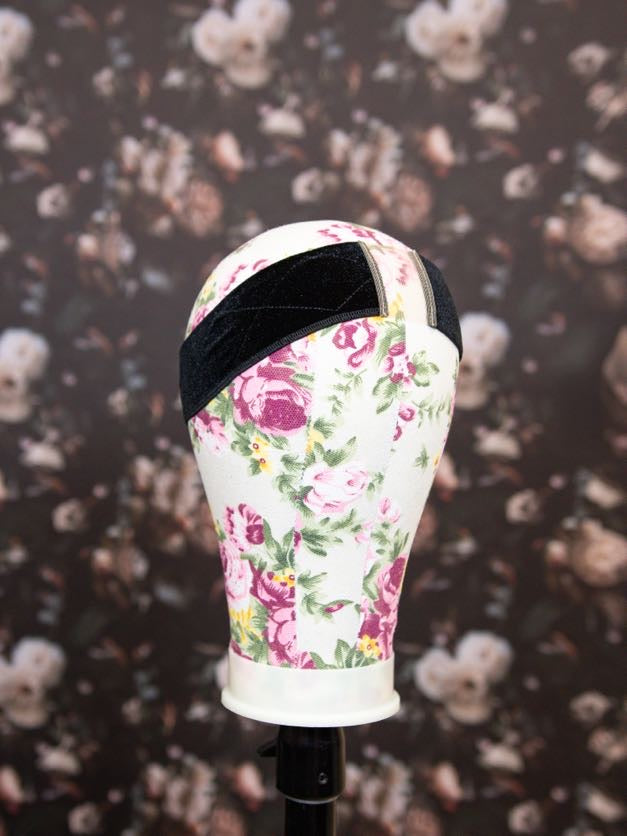 Floral-patterned headband on a mannequin head against a floral background
