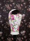 Floral-patterned headband on a dark floral background