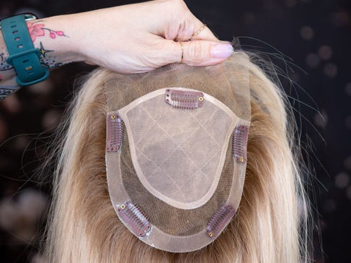 Hairpiece held by a person with a blurred background