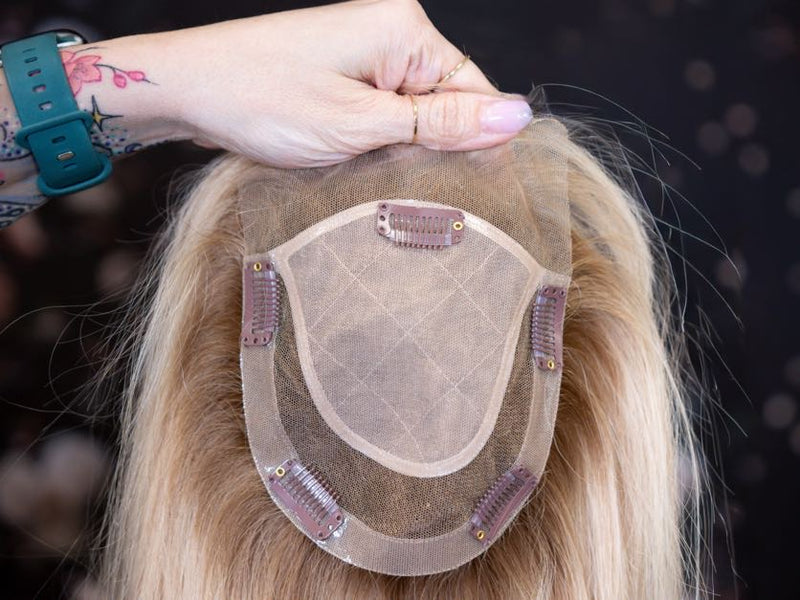 Hairpiece held by a person with a blurred background