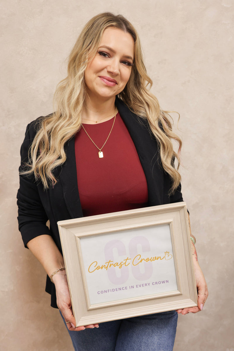 Woman holding a framed certificate with 'Contrast Crown' branding against a beige background
