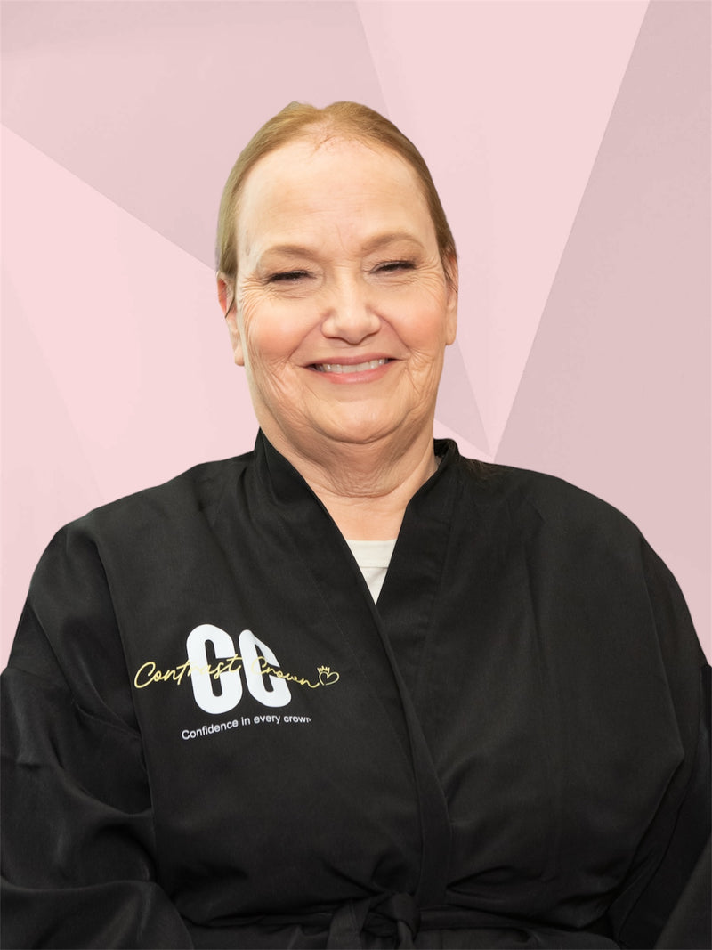 Person wearing a black robe with text on a pink geometric background